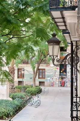 a street light next to a tree and a sidewalk at Apartamento de diseño en la Plaza del Carmen F1 in Valencia