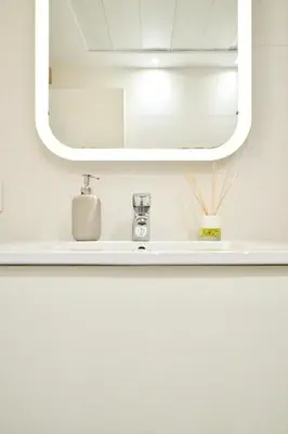 a bathroom with a sink and a mirror at Apartamento de diseño en la Plaza del Carmen F1 in Valencia