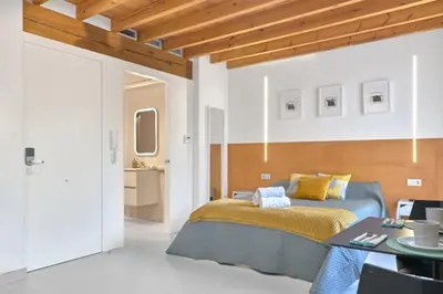 a bedroom with a blue bed and a table at Loft elegante en Plaza del Carmen F3 in Valencia