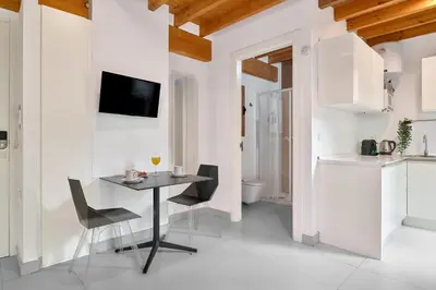 a kitchen and dining room with a table and chairs at Apartamento de diseño en Plaza del Carmen F4 in Valencia