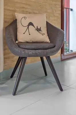 a chair with a camel pillow on it at Apartamento de diseño en Plaza del Carmen F4 in Valencia