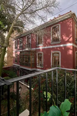 a red house with a fence in front of it at Apartamento de diseño en Plaza del Carmen F4 in Valencia