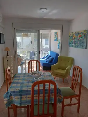 a living room with a table and chairs and a couch at CANETSOL in Canet de Berenguer