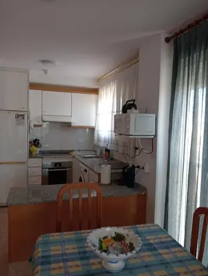 a kitchen with a table with a plate of food on it at CANETSOL in Canet de Berenguer