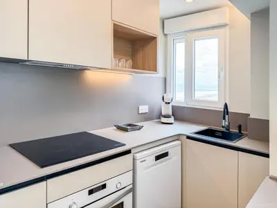 a kitchen with white cabinets and a sink at El Séptimo Cielo de la Bahía de los Naranjos - Primera Línea de Playa in Cullera