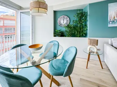 a living room with a glass table and chairs at El Séptimo Cielo de la Bahía de los Naranjos - Primera Línea de Playa in Cullera