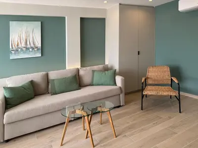 a living room with a couch and a chair at El Séptimo Cielo de la Bahía de los Naranjos - Primera Línea de Playa in Cullera