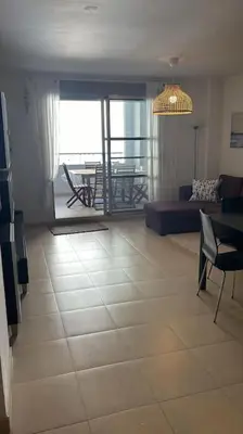a living room with a large tiled floor with a couch at Acogedor apartamento en la playa con WIFI y AACC in Moncófar