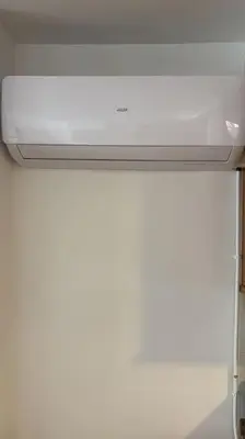 a white refrigerator freezer sitting on top of a counter at Acogedor apartamento en la playa con WIFI y AACC in Moncófar