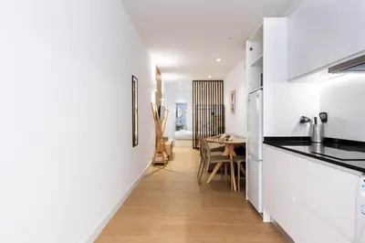 a kitchen with white walls and a dining room at VLC HOST - San Jacinto in Valencia