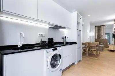 a white kitchen with a washing machine in a room at VLC HOST - San Jacinto in Valencia