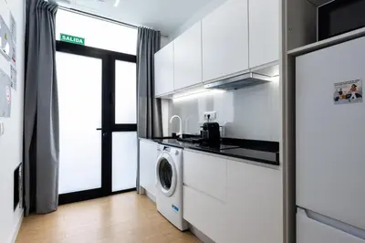 a kitchen with a washer and dryer in a room at VLC HOST - San Jacinto in Valencia