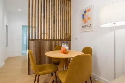 a dining room with a wooden table and chairs at VLC HOST - San Jacinto in Valencia