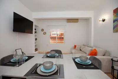 a living room with a table and a couch at Precioso Apartamento en Valencia 2 dormitorios con Parking in Paterna