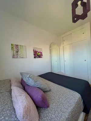 a bedroom with a bed with pillows on it at Apartamento en primera línea de la playa a 15 minutos de la Ciudad de Valencia in Valencia