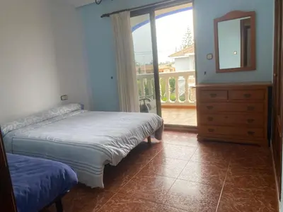 a bedroom with a bed and a mirror and a window at 1era linea de playa VILLA SALES Cullera Marenyet in Cullera
