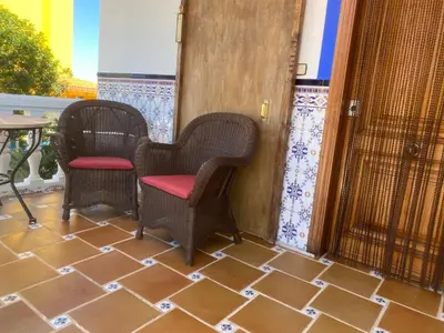 two chairs and a table on a patio at 1era linea de playa VILLA SALES Cullera Marenyet in Cullera
