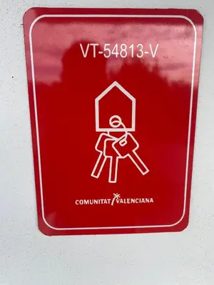 a red sign with a picture of a person on it at Casa the Dutchman in Navarrés