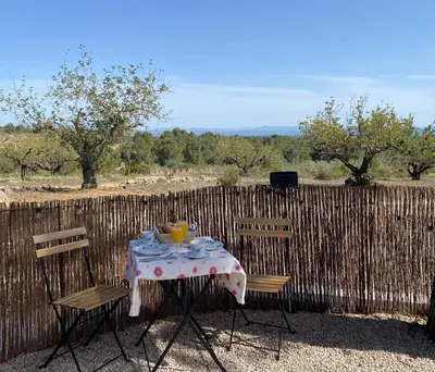 a table and two chairs with a table and a bowl of food at Casa the Dutchman in Navarrés
