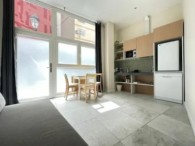 a kitchen with a table and a tv in a room at Calma Lofts in Valencia