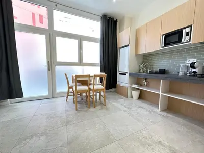 a kitchen with a table and chairs in a room at Calma Lofts in Valencia