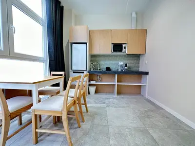 a kitchen with a table and chairs and a refrigerator at Calma Lofts in Valencia