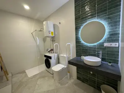 a bathroom with a toilet and a sink and a mirror at Calma Lofts in Valencia