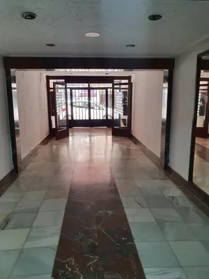 an empty room with glass doors and a tiled floor at apartamento playa surf cullera in Cullera