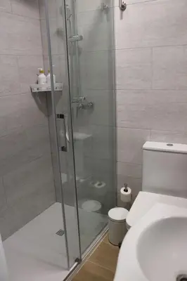 a bathroom with a shower with a toilet and a sink at La Casa del Castell in Onda