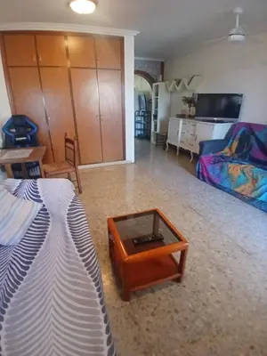 a living room with a bed and a coffee table at Casa del Cerro in Eslida