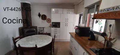 a kitchen with a table and a stove at Casa del Cerro in Eslida