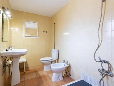a bathroom with a toilet and a sink and a shower at Holiday Home D'estiu by Interhome in El Grao