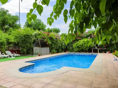 a swimming pool in a yard with plants at Holiday Home D'estiu by Interhome in El Grao