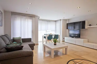 a living room with a couch and a table at Cómodo y luminoso apto cerca de Playas y Valencia in Sueca