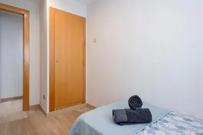 a bedroom with a bed with a towel on it at Cómodo y luminoso apto cerca de Playas y Valencia in Sueca