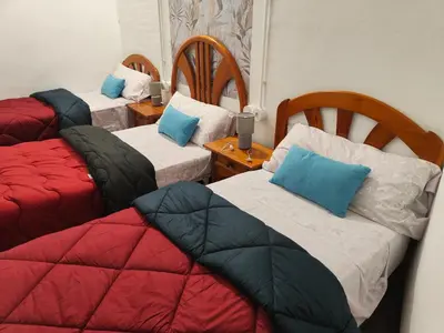 a room with three beds with pillows on them at Casa Voramar in Cullera