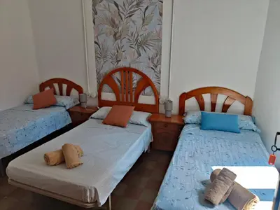 a bedroom with a bed with a pillow on it at Casa Voramar in Cullera
