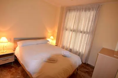 a bedroom with a bed with two towels on it at MUY BIEN SITUADO LAS CIENCIAS n in Valencia