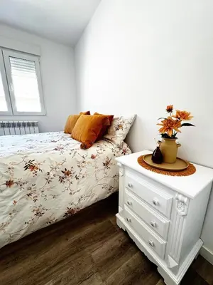 a bedroom with a bed with a white dresser and a window at Moderno Piso en Puerto Sagunto in Puerto de Sagunto