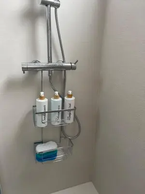 a bathroom with three rolls of toilet paper on a shelf at Moderno Piso en Puerto Sagunto in Puerto de Sagunto