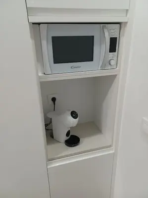 a microwave sitting on top of a shelf at Apartamento Turístico en Valencia in Valencia
