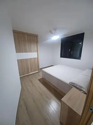 a white room with a bed and a cabinet at Apartamento Turístico en Valencia in Valencia