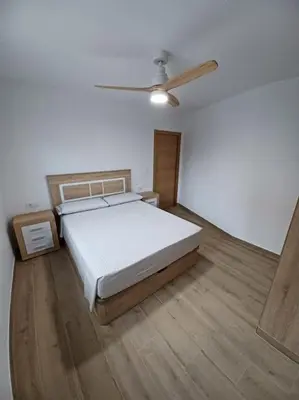 a bedroom with a bed and a ceiling fan at Apartamento Turístico en Valencia in Valencia