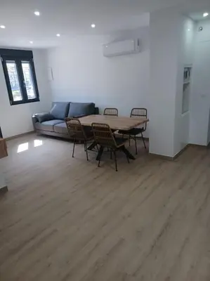 a living room with a table and chairs and a couch at Apartamento Turístico en Valencia in Valencia
