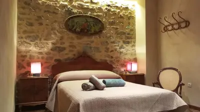 a bedroom with a bed with two pillows on it at Casa rural Puchero y Manta in Alcudia de Veo
