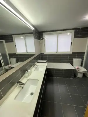 a bathroom with a sink and a toilet and a mirror at 3 Bed Chalet-Pool-Pets-Hot Tub-Parking-Garden in Chiva