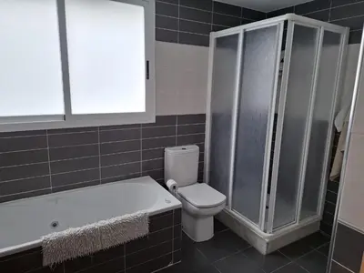 a bathroom with a toilet and a shower and a sink at 3 Bed Chalet-Pool-Pets-Hot Tub-Parking-Garden in Chiva