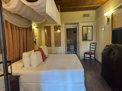a bedroom with a large white bed and a television at Masía De Lacy in Museros