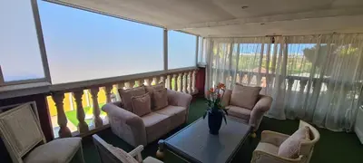 a living room with two chairs and a table on a balcony at Masía De Lacy in Museros