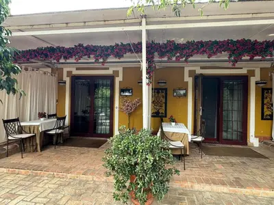 a patio with a table and chairs and flowers at Masía De Lacy in Museros